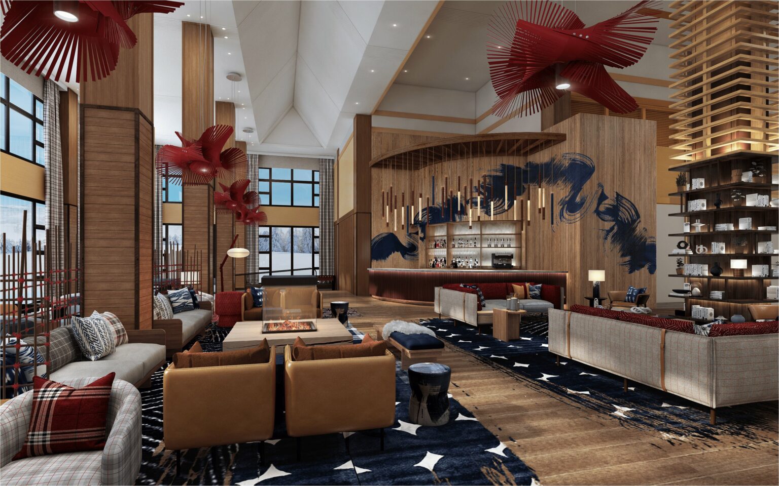 A modern hotel lobby lounge with a warm, inviting ambiance. It features stylish seating, a central fireplace, artful red decorations, and rich wooden accents.
