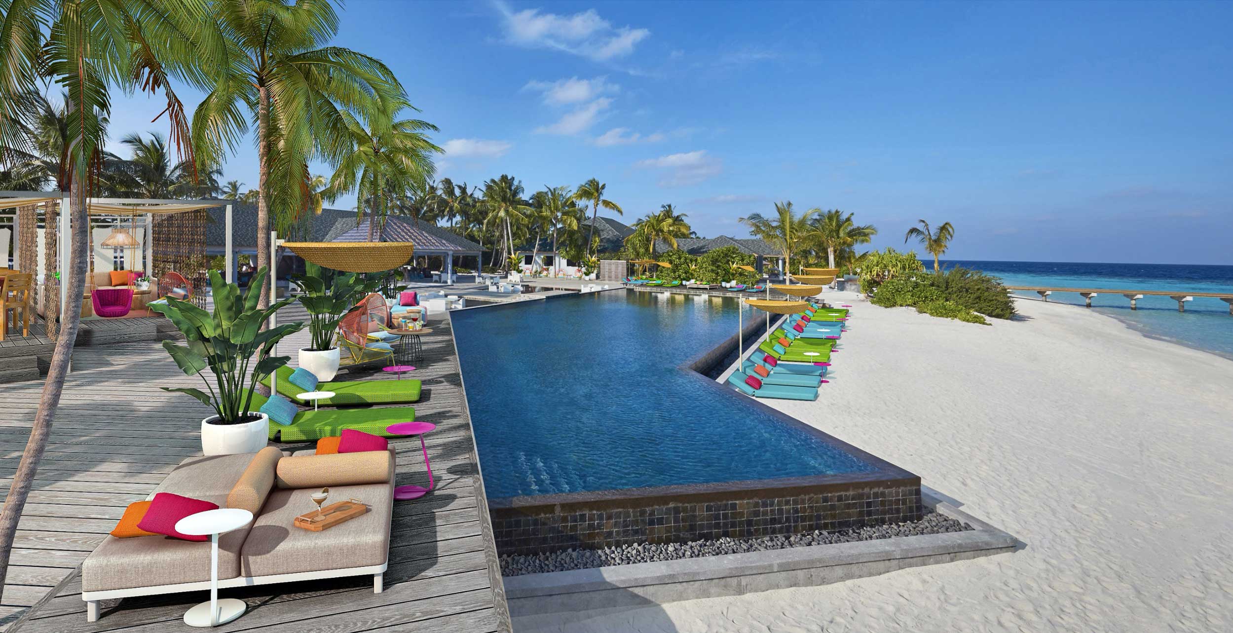 Tropical beach resort with infinity pool, lined with colorful lounge chairs. Palm trees and a sandy beach meet a clear blue ocean under a sunny sky. Luxurious and serene ambiance.